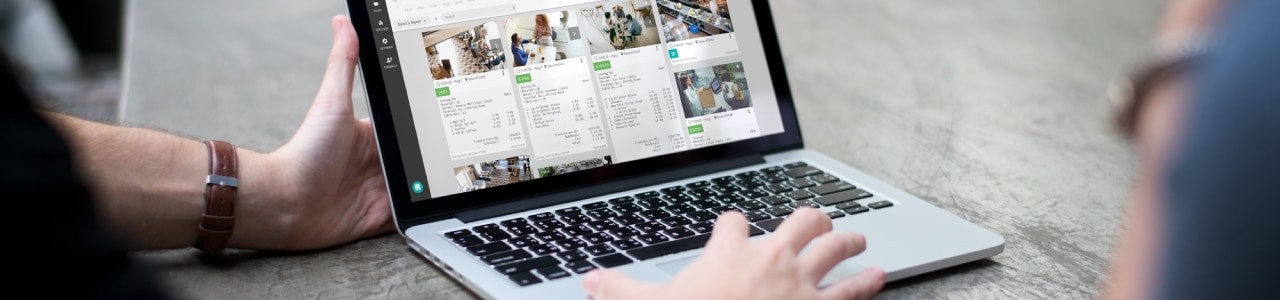 A person is using a laptop with a picture on it.