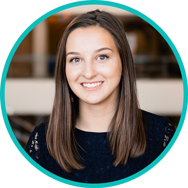 A woman with brown hair smiling in a circle.